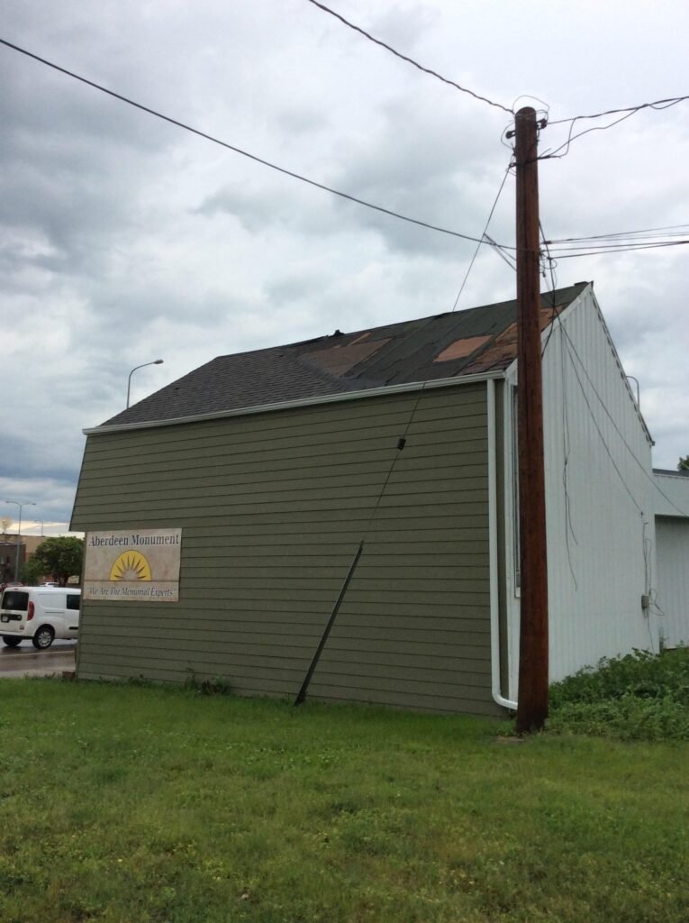 Wind-damaged roof with missing shingles in Aberdeen