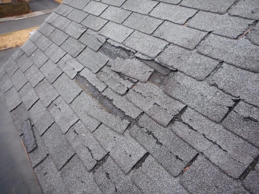Cracked and deteriorated asphalt roof shingles